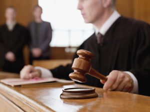 A judge in criminal court with gavel in hand