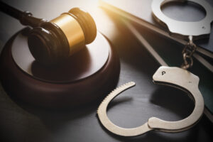 Judge's Gavel and handcuffs over the book