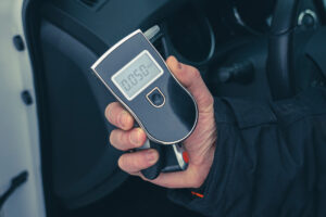 A breathalyzer in the hand of a man