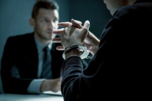 Man in Handcuff with investigation office