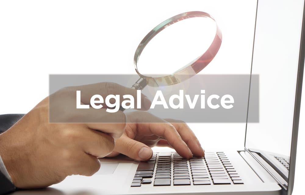 Hand holding magnify glass with word Legal Advice