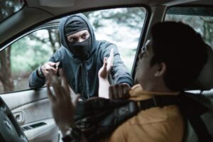 Bandit robs man's car. He is threatening her then man is shocked in the car on parking area 